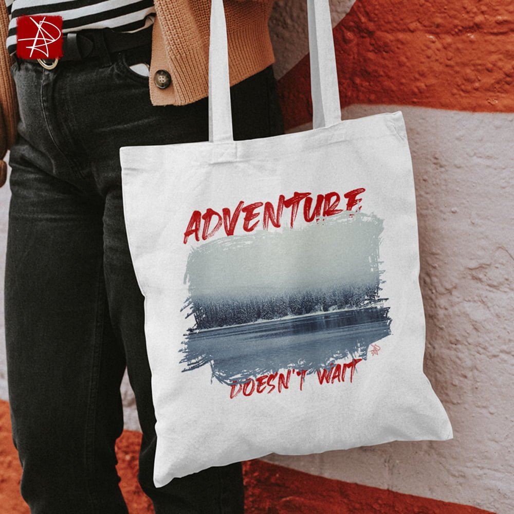 Adventure Does Not Wait Tote Bag - A Winter Landscape of a Frozen Lake Surrounded by a Forest