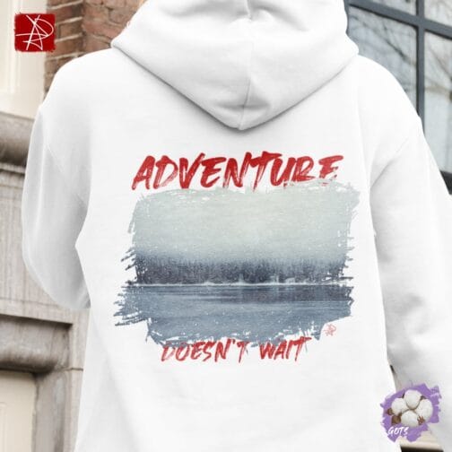 Unisex organic cotton hoodie with “Adventure Does Not Wait” winter forest design and front pouch pocket – sustainable, GOTS certified, and eco-friendly fashion.